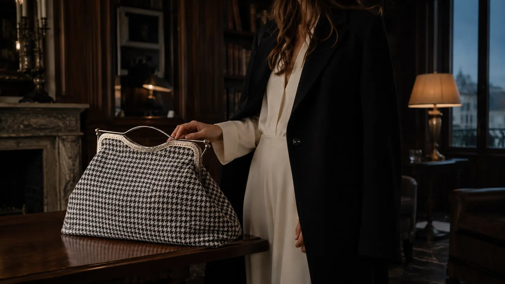 Person holding a black and white checkered handbag in an indoor setting