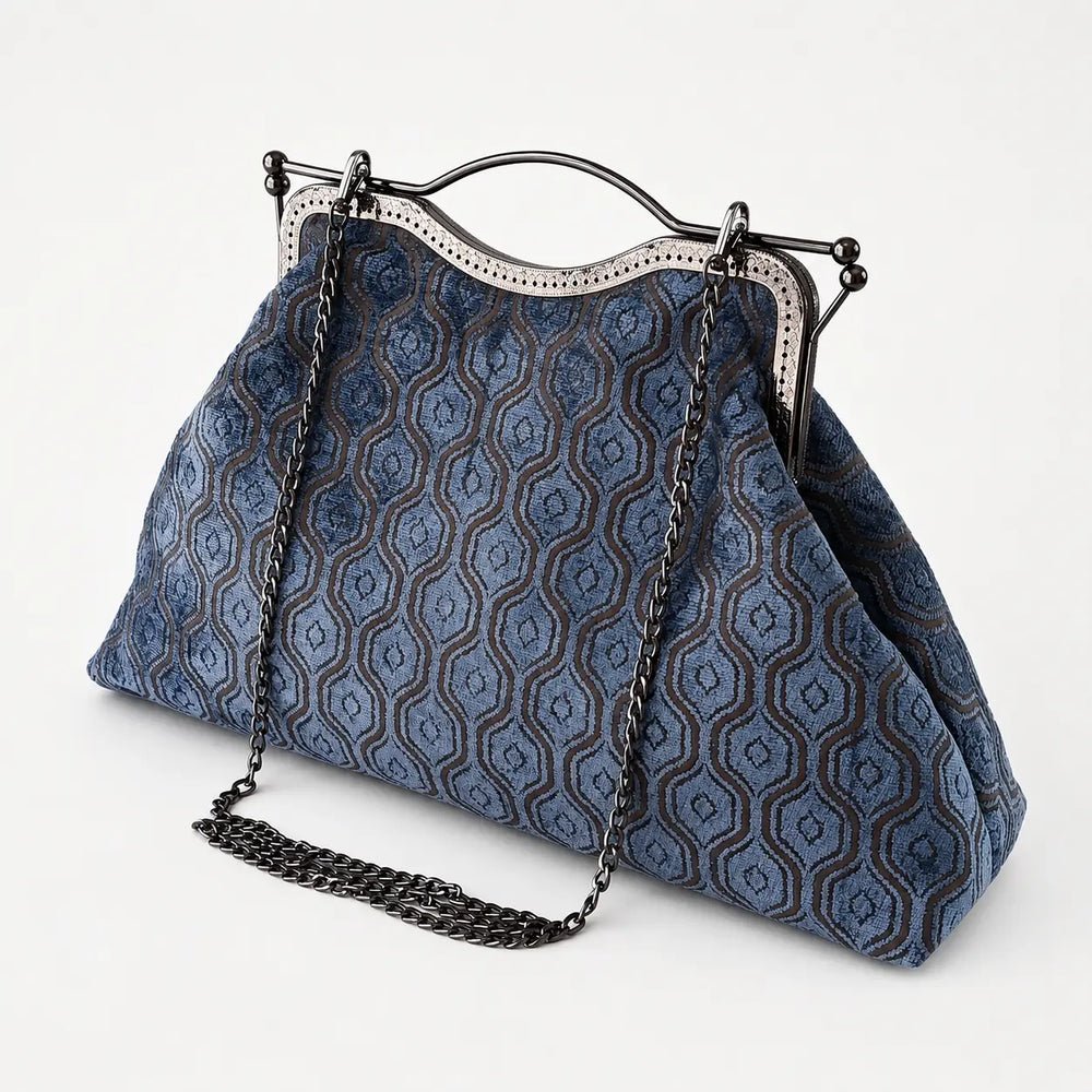 Blue patterned handbag with a chain strap on a white background