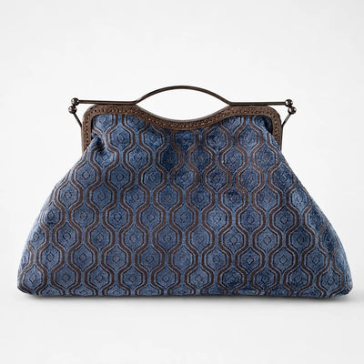 Blue patterned handbag with a brown handle on a white background