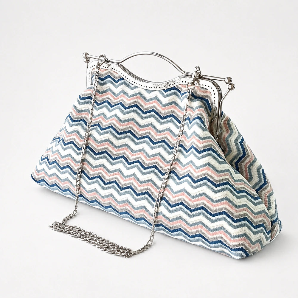 Patterned handbag with a chain strap on a white background