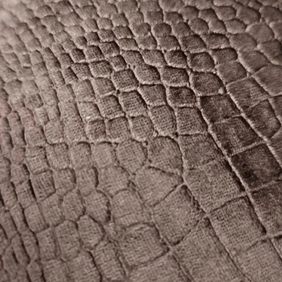 Close-up of textured black fabric with a diamond pattern