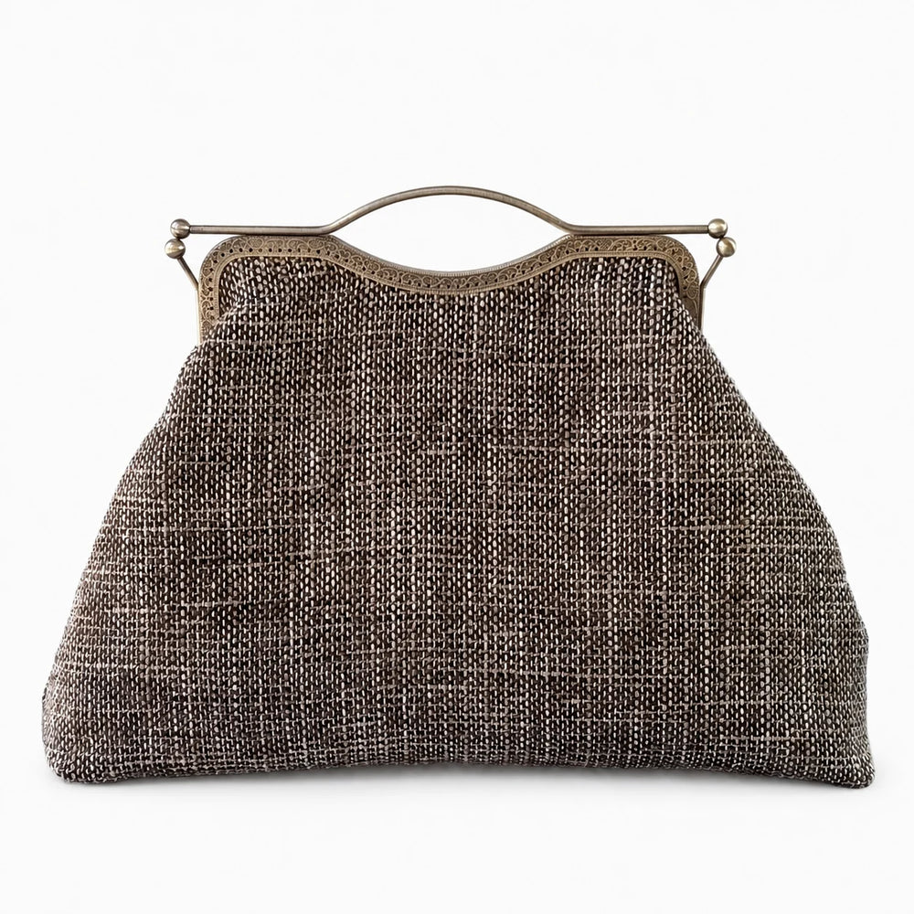 Vintage-style handbag with metallic frame on a white background