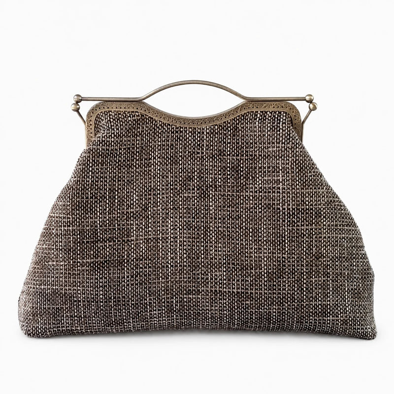 Vintage-style handbag with metallic frame on a white background