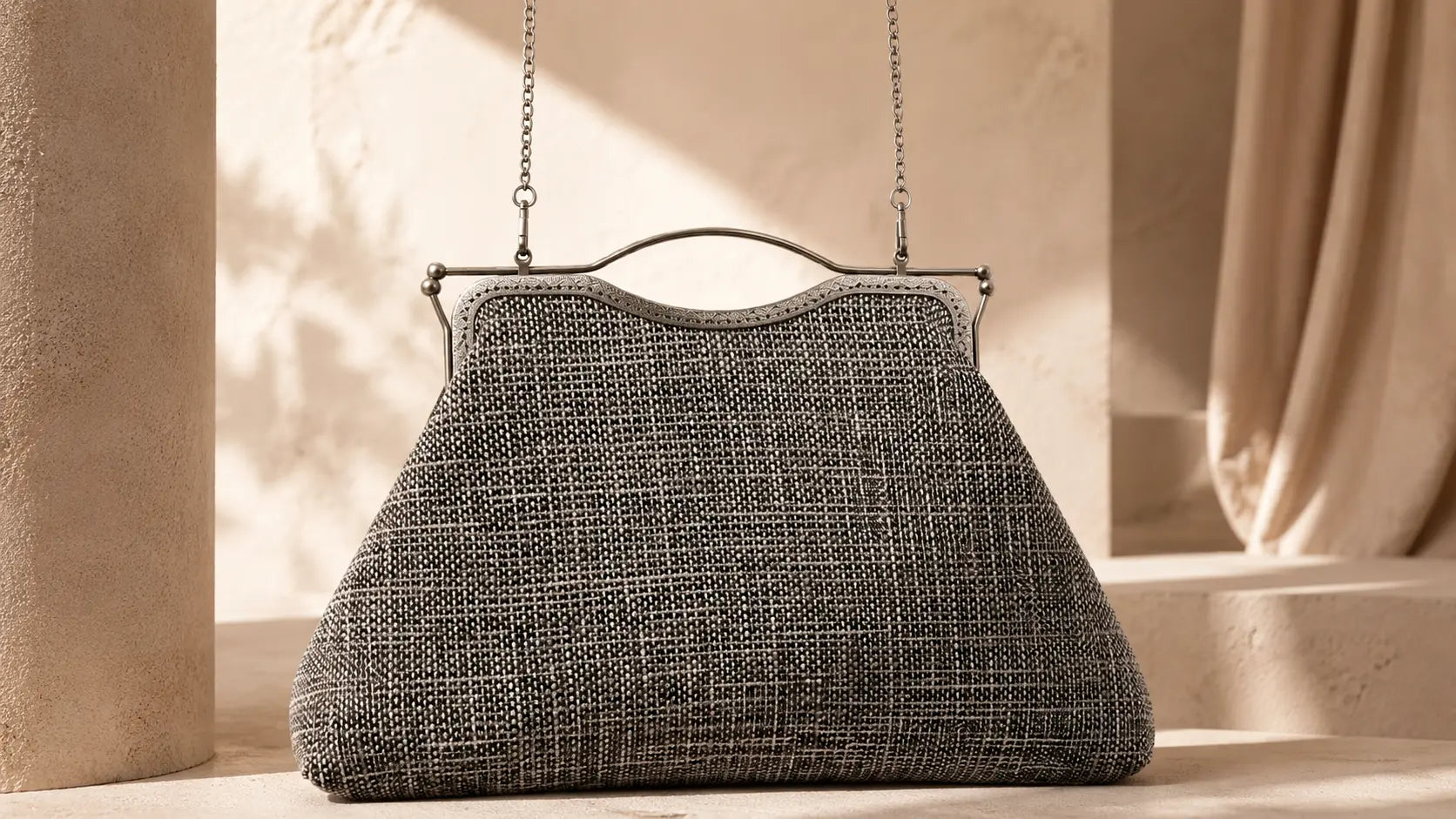 Textured handbag with a chain strap on a neutral background