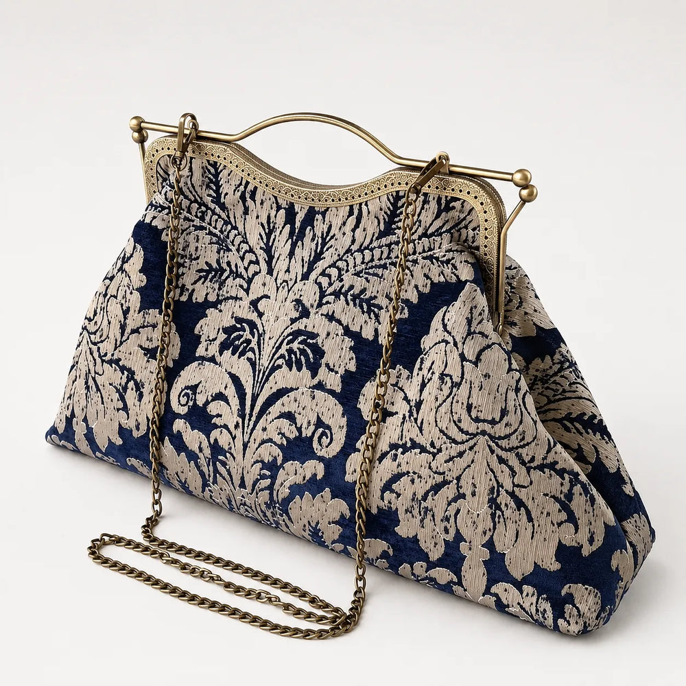 Blue and white patterned handbag with a gold chain on a white background