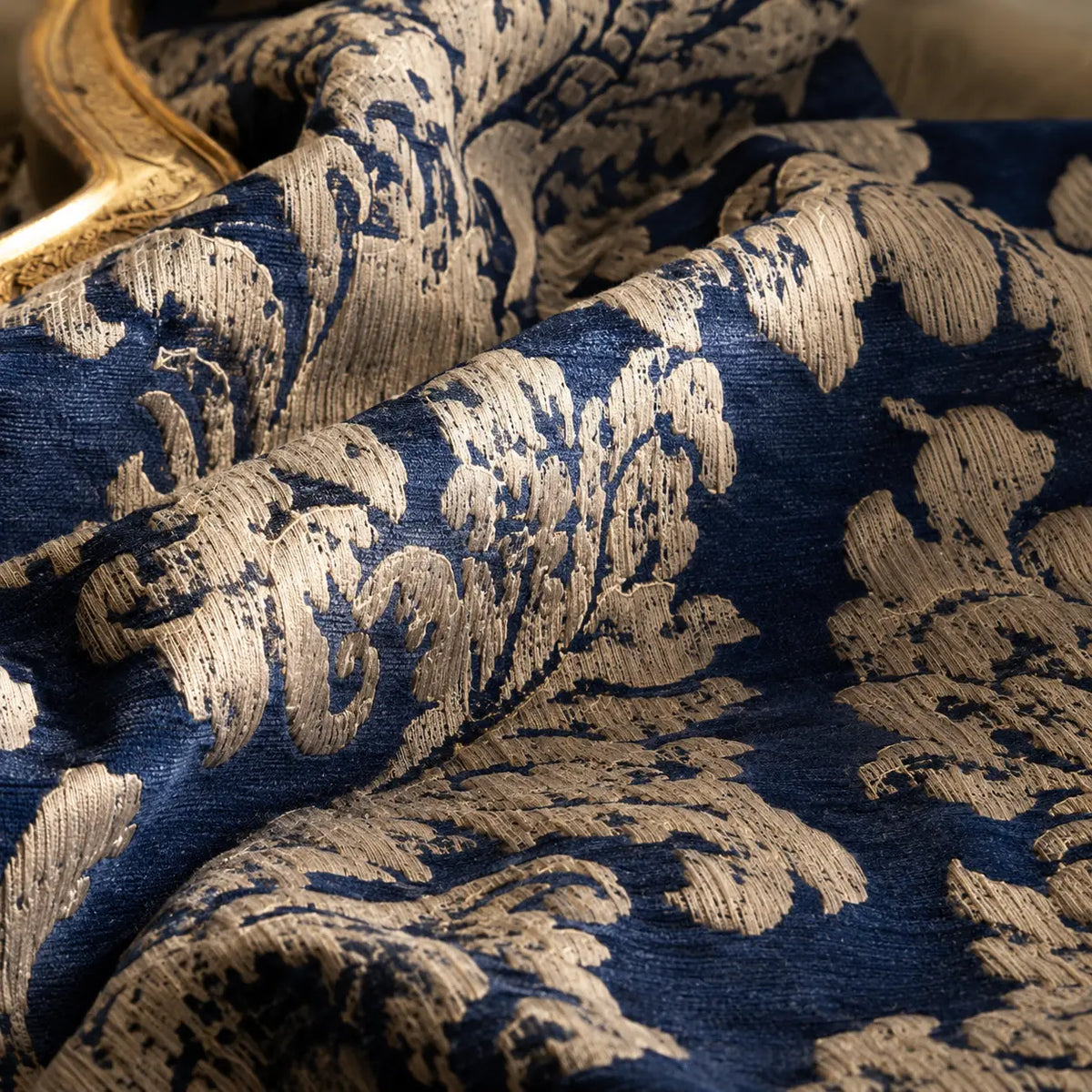 Laser-treated jacquard tapestry with an ornate woven structure and softly distressed depth.